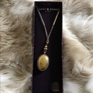 Brand new Reversible silver/gold pendant